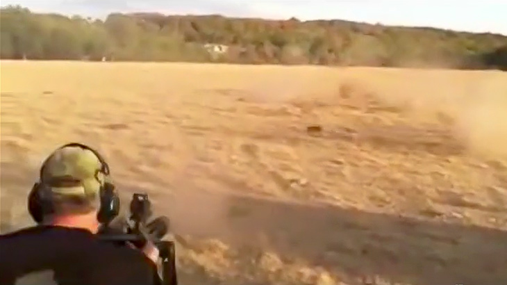 機関銃でイノシシを撃ち殺すハンターの映像。