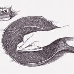 汚くなった鉄板を綺麗に掃除する、お店で働く男のルーティンワーク